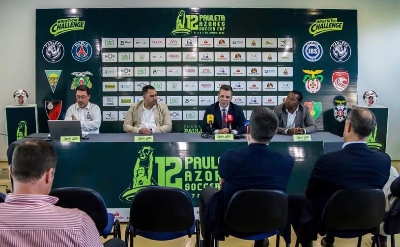 Press conference for the Pauleta Azores Soccer Cup in Portugal, with the JBS FC and Paris Saint-Germain logos displayed and Portuguese soccer legends at the table.
